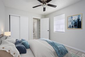 Titusville apartment for rent - a bedroom with a large bed and a ceiling fan