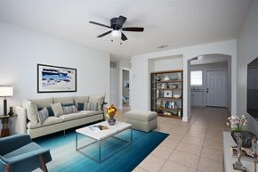 Titusville apartment for rent - a living room with a couch and a coffee table and a ceiling fan