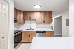 Cicero apartment for rent - A kitchen with wooden cabinets and stainless steel appliances.