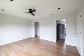 Albany apartment for rent - A room with a ceiling fan and wooden flooring.