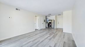 Cape Canaveral apartment for rent - A spacious room with a kitchen area in the background.