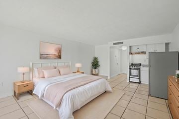 Merritt Island apartment for rent - A bedroom with a large bed and a painting on the wall.