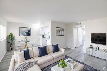 Fort Myers apartment for rent - A living room with a white couch and a glass coffee table.