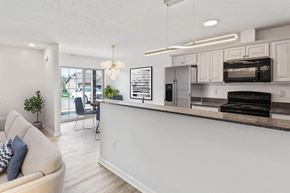 Brockport apartment for rent - an open living room and kitchen with a counter top and