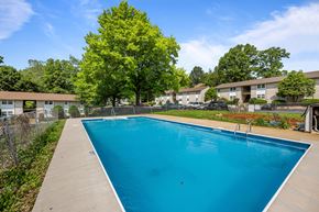 Staunton apartment for rent - A blue swimming pool surrounded by a fence and trees.