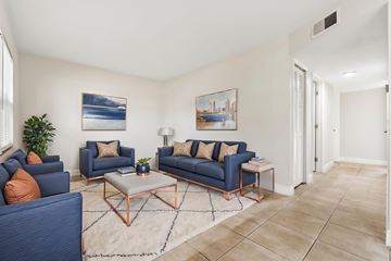 Fort Myers apartment for rent - A living room with blue couches and a white rug.