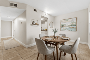 Fort Myers apartment for rent - A dining room with a table set for two and a painting on the wall.