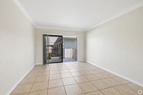 Fort Myers apartment for rent - A room with a tiled floor and a staircase with a metal railing.