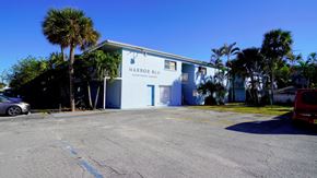 Cape Canaveral apartment for rent - A building with a sign that says Harbor Blue.