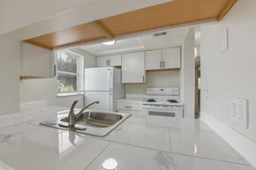 Fort Myers apartment for rent - A kitchen with a sink and a stove top oven.