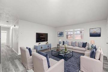 Staunton apartment for rent - A living room with a grey carpet and a white sofa.