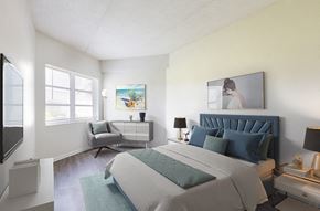 Merritt Island apartment for rent - A bedroom with a large bed and a painting on the wall.