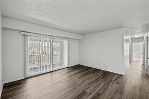 Staunton apartment for rent - A spacious room with wooden flooring and white walls.