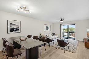 Fort Myers apartment for rent - A modern dining room with a glass table and chairs.