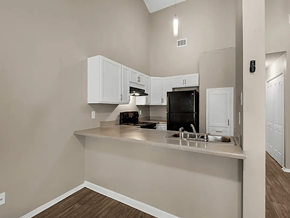 Pensacola apartment for rent - a kitchen with white cabinets and a counter top