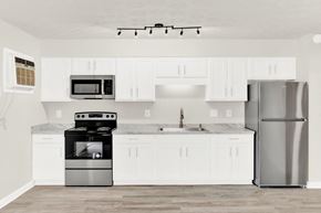 Staunton apartment for rent - a white kitchen with stainless steel appliances and white cabinets