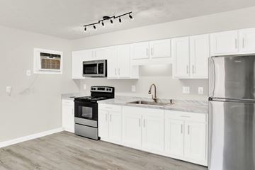 Staunton apartment for rent - a kitchen with white cabinets and stainless steel appliances
