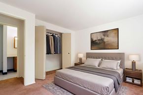 Cicero apartment for rent - A bedroom with a large bed and a painting on the wall.