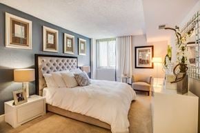 Alexandria apartment for rent - A bedroom with a large bed and a nightstand with a lamp.