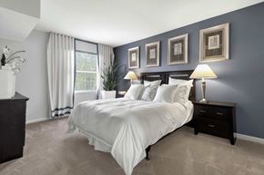 Springfield apartment for rent - A bedroom with a large bed and a window with curtains.