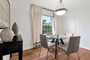 Springfield apartment for rent - A dining room with a table set for two and a view of the backyard.