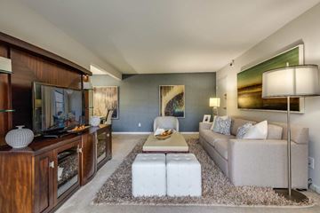 Springfield apartment for rent - A modern living room with a grey sofa and a wooden cabinet.