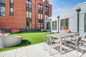 Dulles apartment for rent - A modern outdoor dining area with a table and chairs.