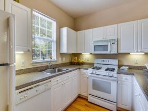 Dulles apartment for rent - a kitchen with white appliances and white cabinets