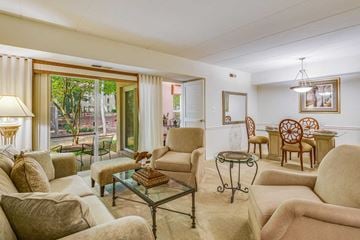 Reston apartment for rent - A living room with a glass table and chairs.