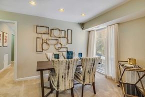 Forestville apartment for rent - A dining room with a table set for two and a decorative wall piece.