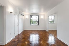 Indianapolis apartment for rent - A room with wooden floors and two windows.