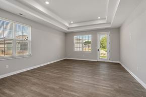 White Lake apartment for rent - Living room with light wood flooring and white walls at Encore at West Valley, Michigan