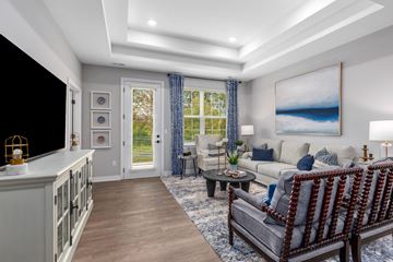 White Lake apartment for rent - A modern living room with a grey sofa and a painting on the wall.