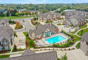 Novi apartment for rent - an aerial view of a pool and houses in a neighborhood at Encore at Manchester, Novi, 48377