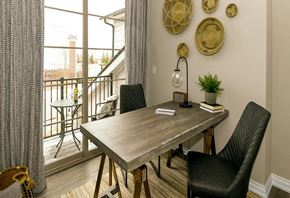 Novi apartment for rent - a dining room with a table and chairs and a balcony at Encore at Manchester, Michigan