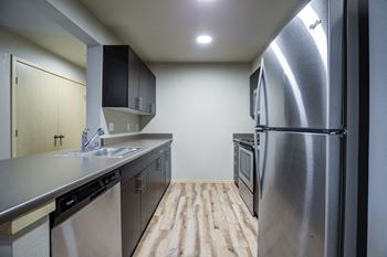Fully equipped kitchen with refrigerator, microwave, & dishwasher