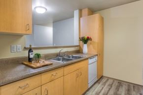 Everett apartment for rent - A kitchen with wooden cabinets and a granite countertop.