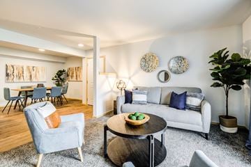 Everett apartment for rent - a living room with a couch and a coffee table and a dining room
