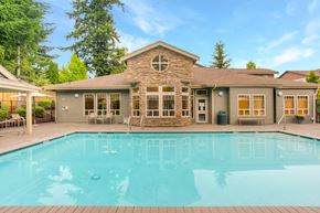 Renton apartment for rent - a swimming pool in front of a house