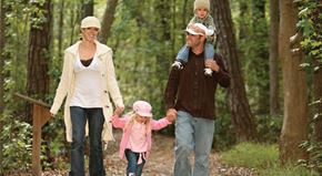 Renton apartment for rent - A family of three walking in the woods.