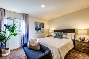 Auburn apartment for rent - a bedroom with a bed and a chair and a window