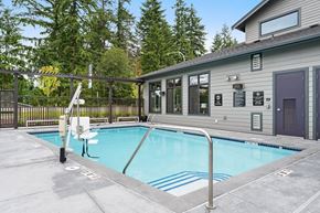 Auburn apartment for rent - a swimming pool is next to a house with a fence