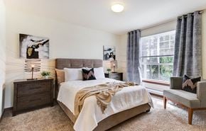 Bothell apartment for rent - a bedroom with a bed and a chair and a window