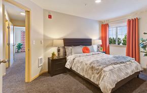 Redmond apartment for rent - a bedroom with a bed and a window with red curtains