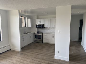 Lindsay apartment for rent - A kitchen with white cabinets and a stainless steel oven.