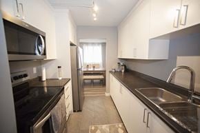 Cornwall apartment for rent - A kitchen with black countertops and stainless steel appliances.