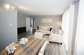 Cornwall apartment for rent - A living room with a white couch and a wooden table.