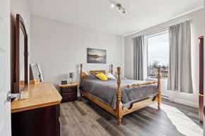Thurso apartment for rent - A bedroom with a four poster bed and a wooden dresser.