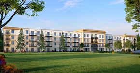 Saint John townhouse for rent - A large building with a lawn in front of it.