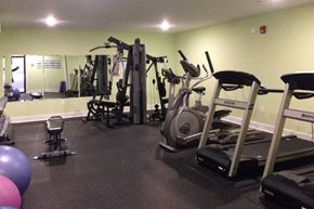 Saint John townhouse for rent - A gym with a variety of equipment including treadmills, weights, and exercise balls.